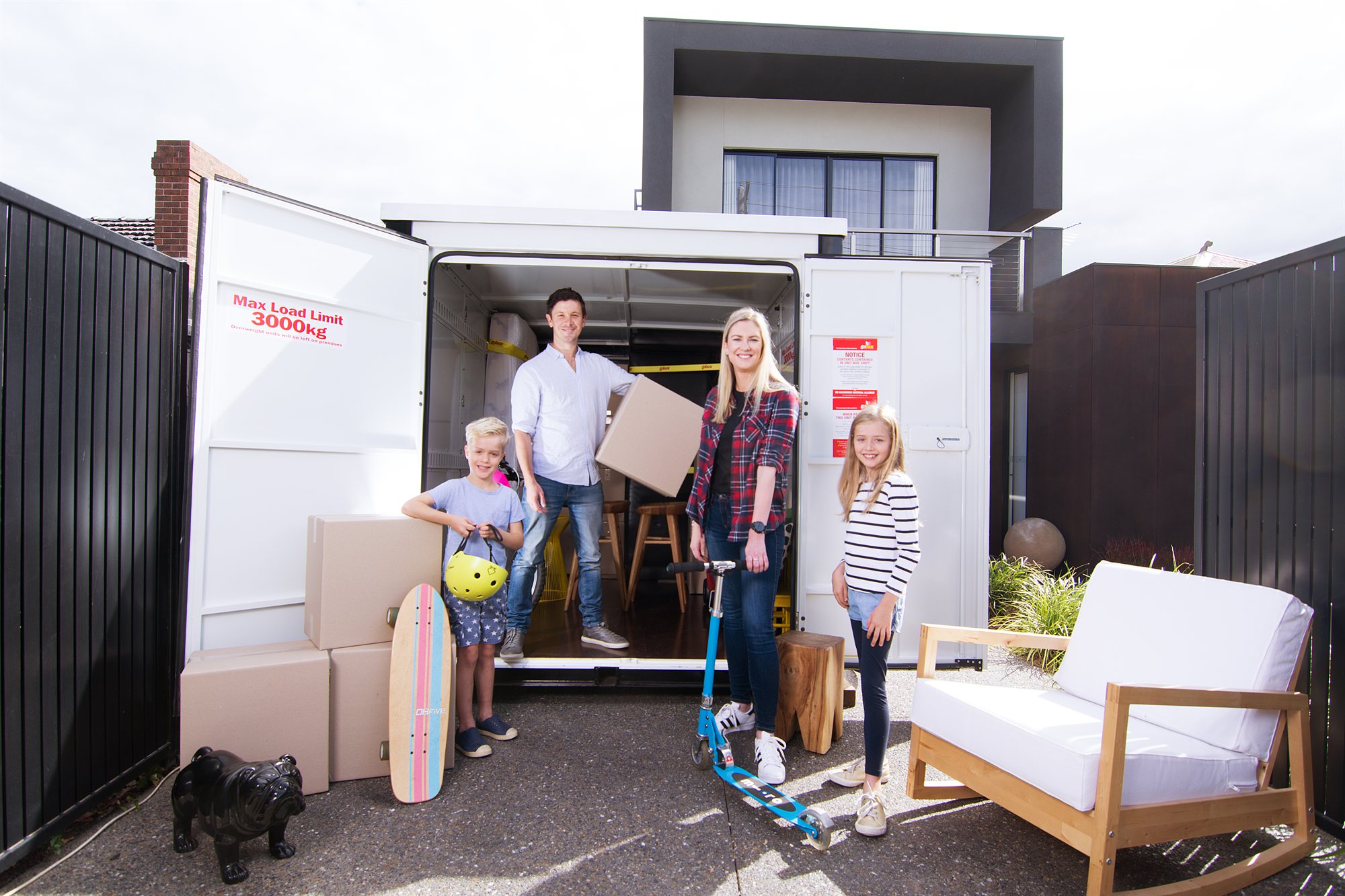 Family loading their gobox mobile storage unit at home
