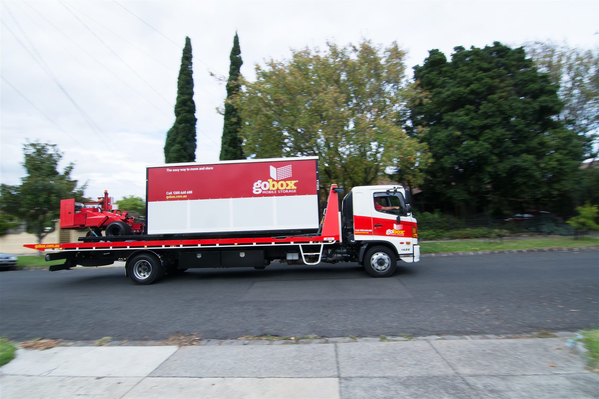 A gobox truck delivering a portable storage unit to site