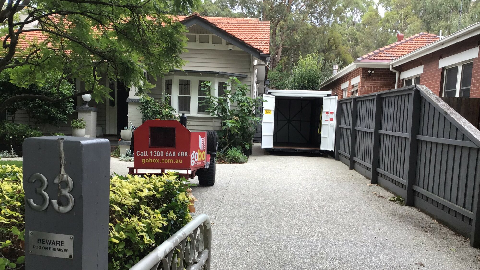 gobox temporary storage unit with doors open on a residential driveway