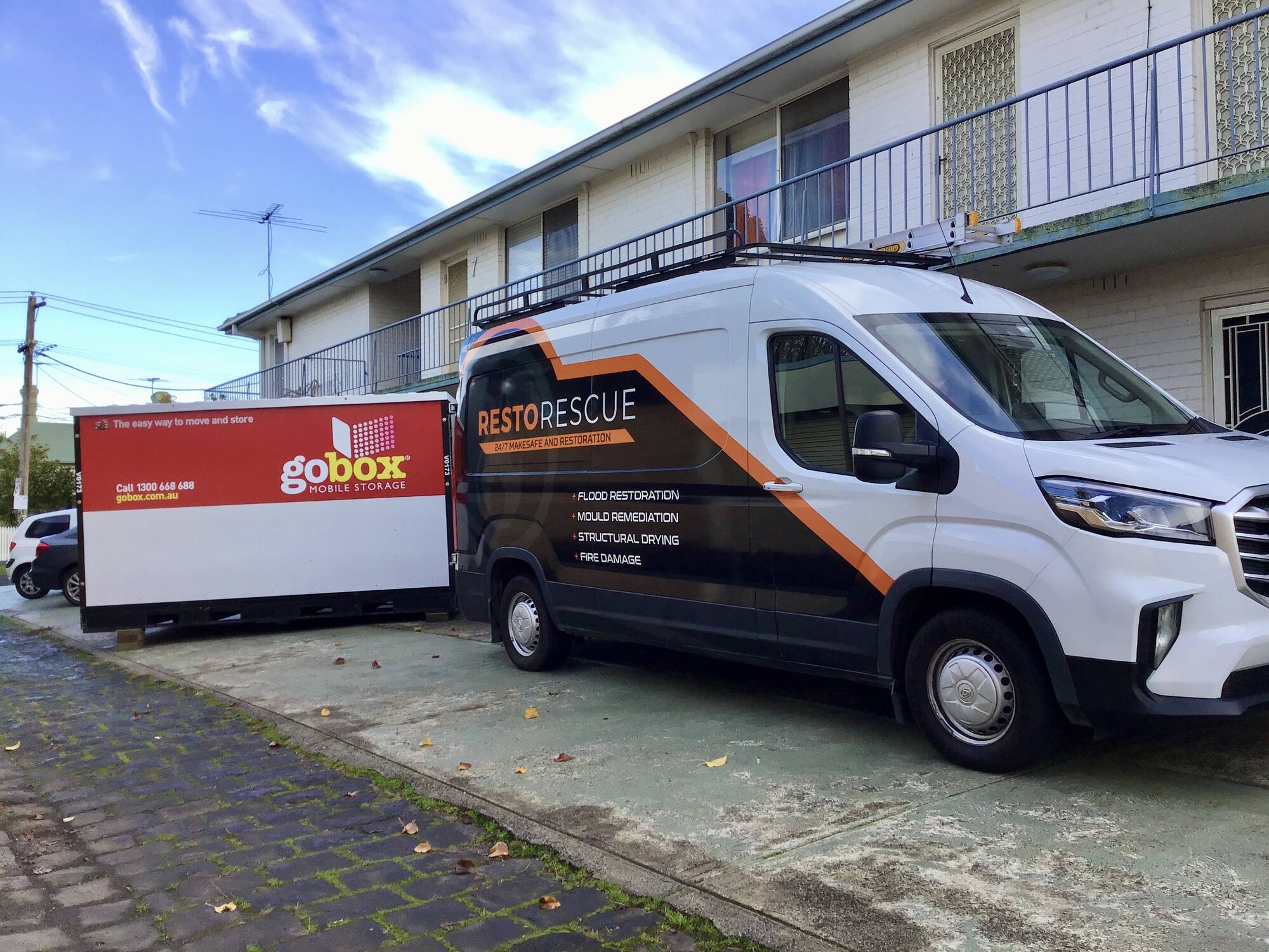 gobox unit and a restoration contractor's van at a job site