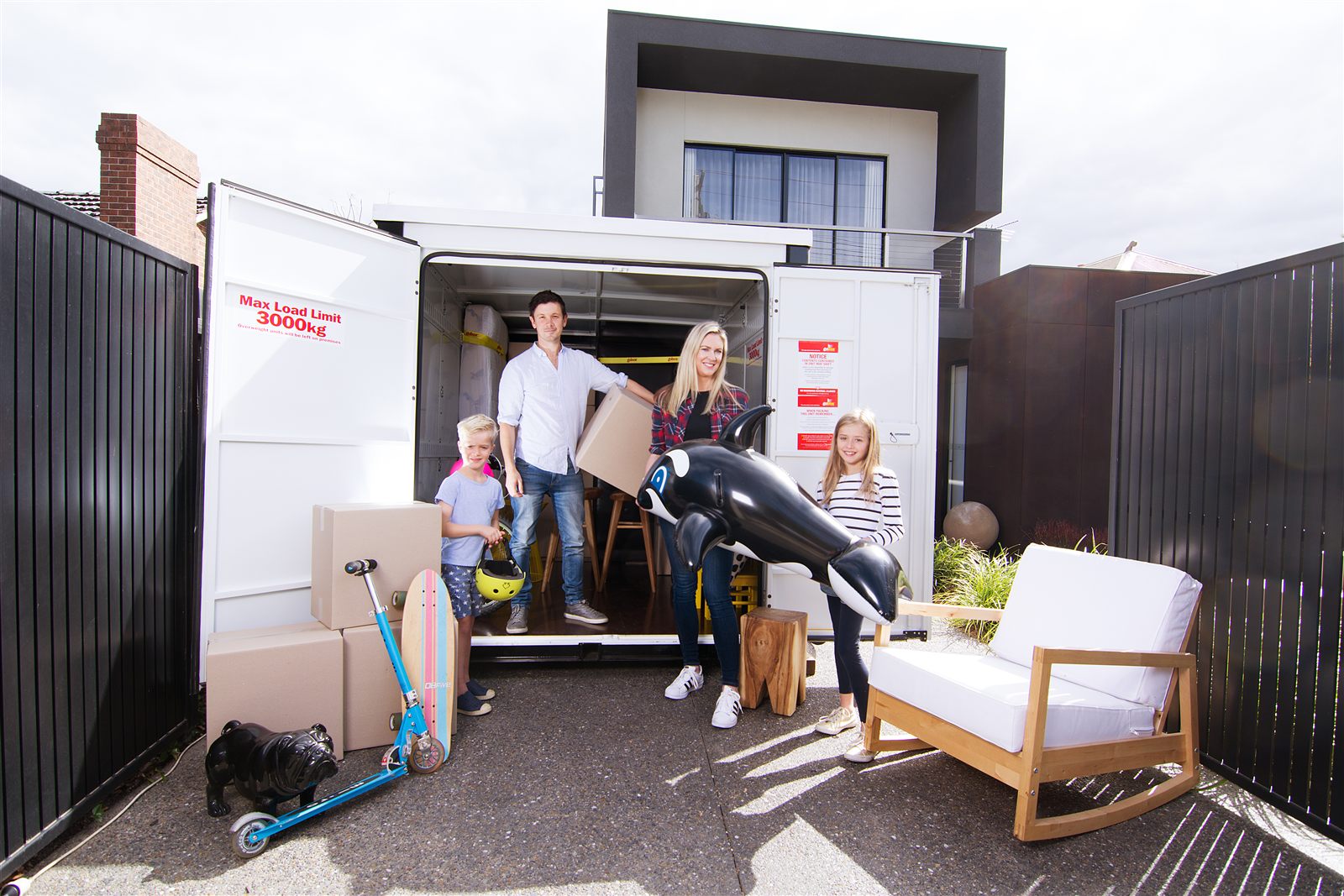 Family loading household belongings into their gobox storage unit