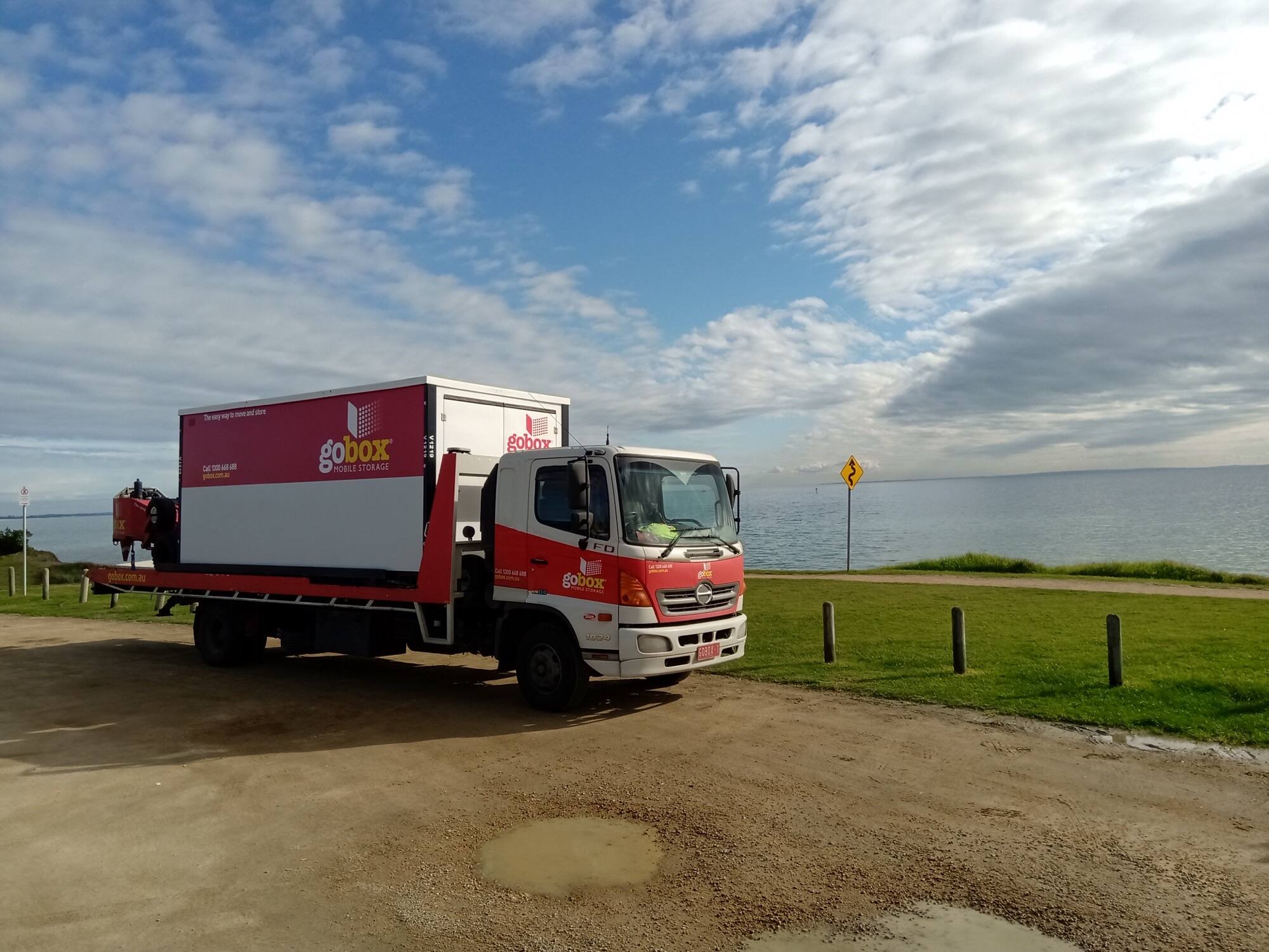 gobox truck with a loaded storage unit parked by the bay