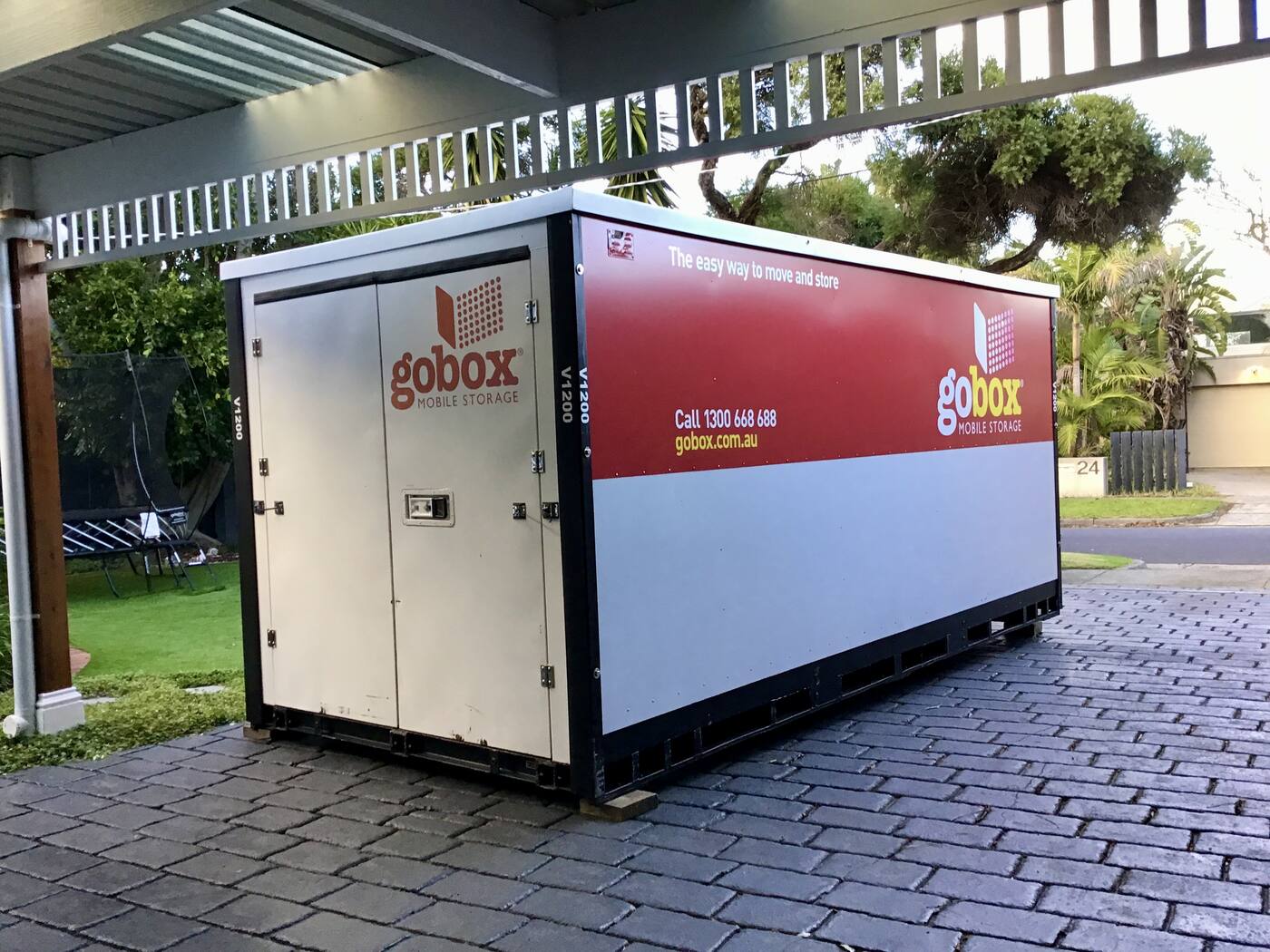 gobox unit positioned on a cobbled driveway beside the house
