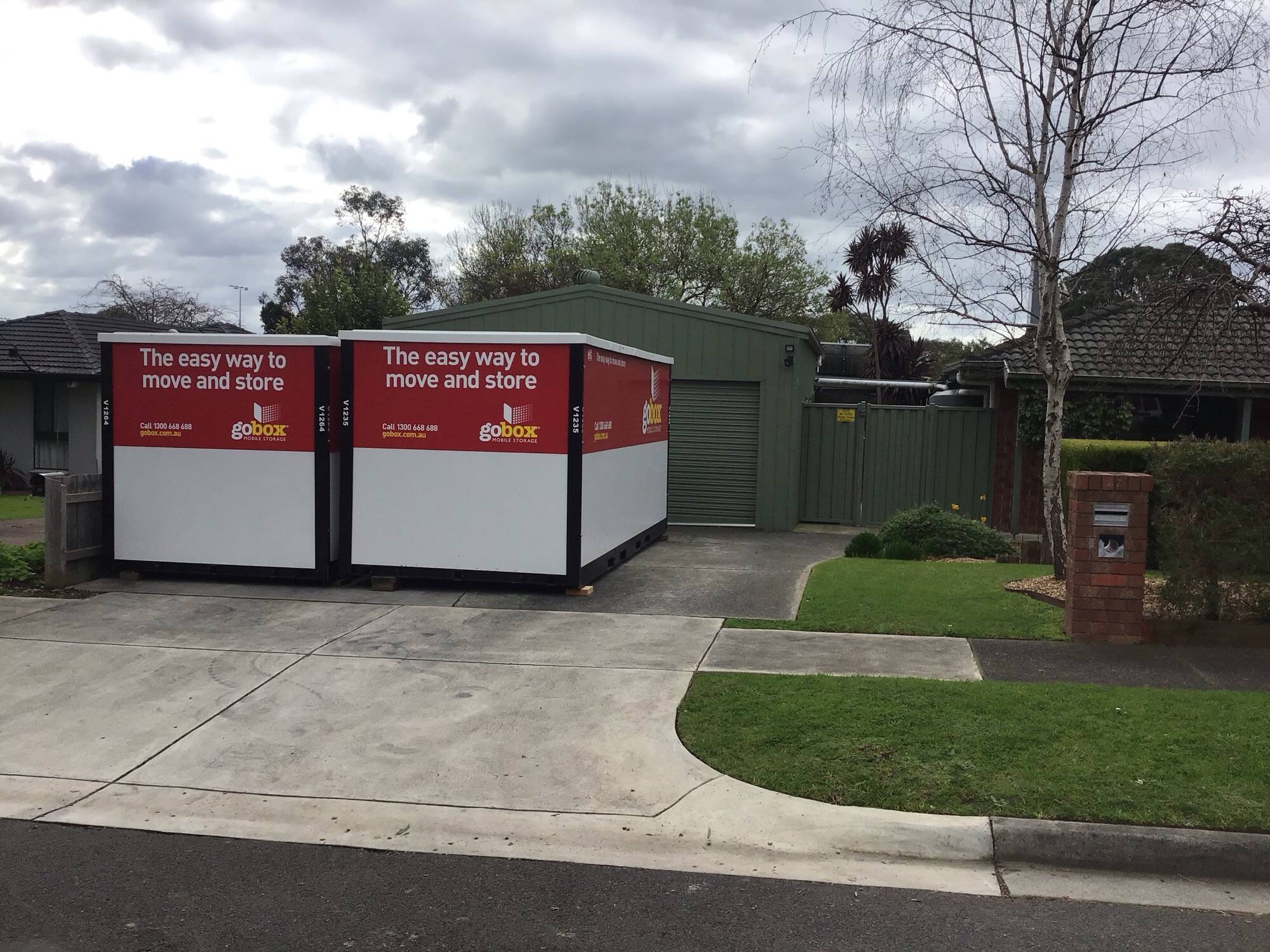 Two gobox units on a driveway in front of a suburban home