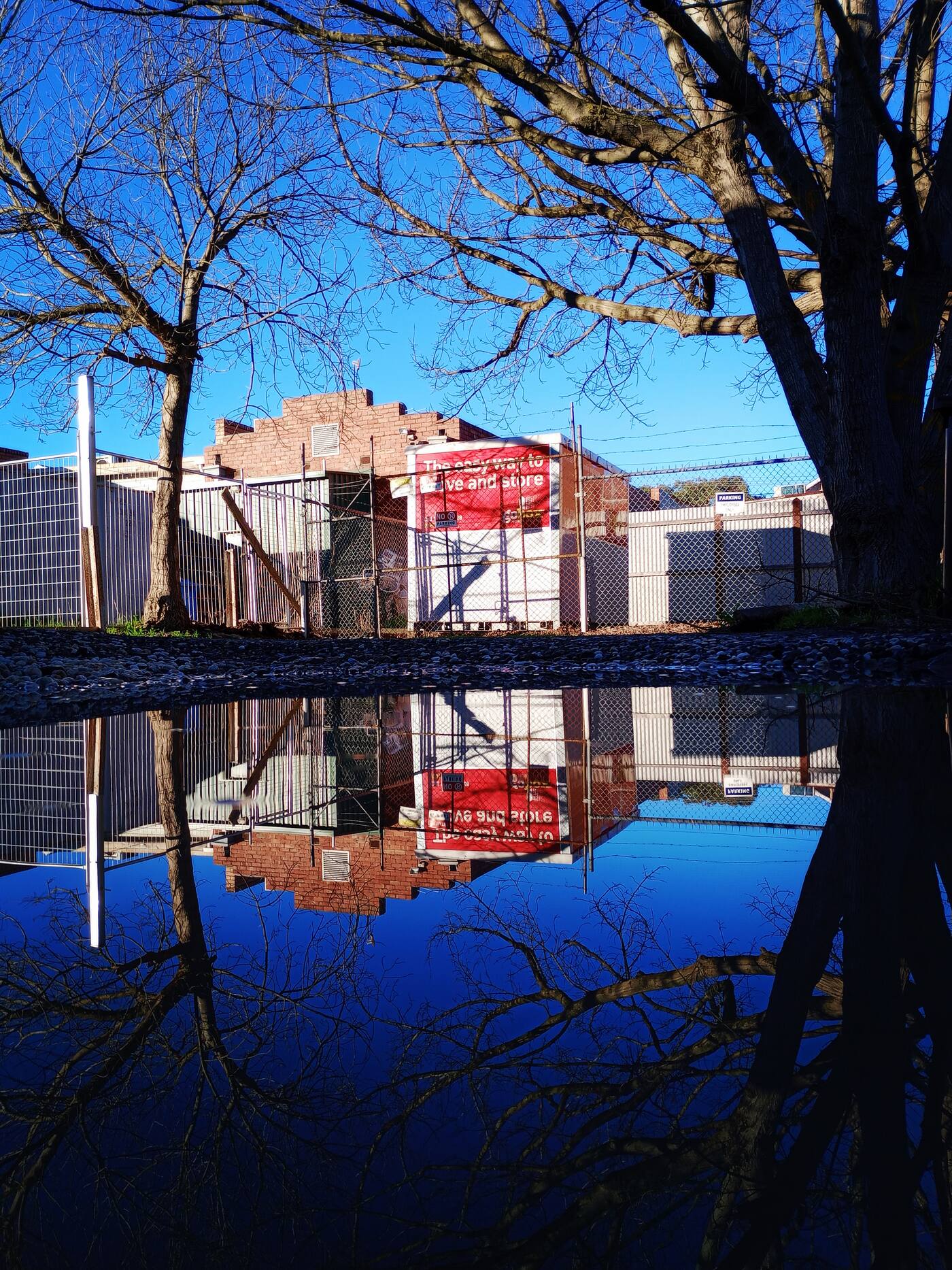 gobox unit reflected in a puddle on a work site