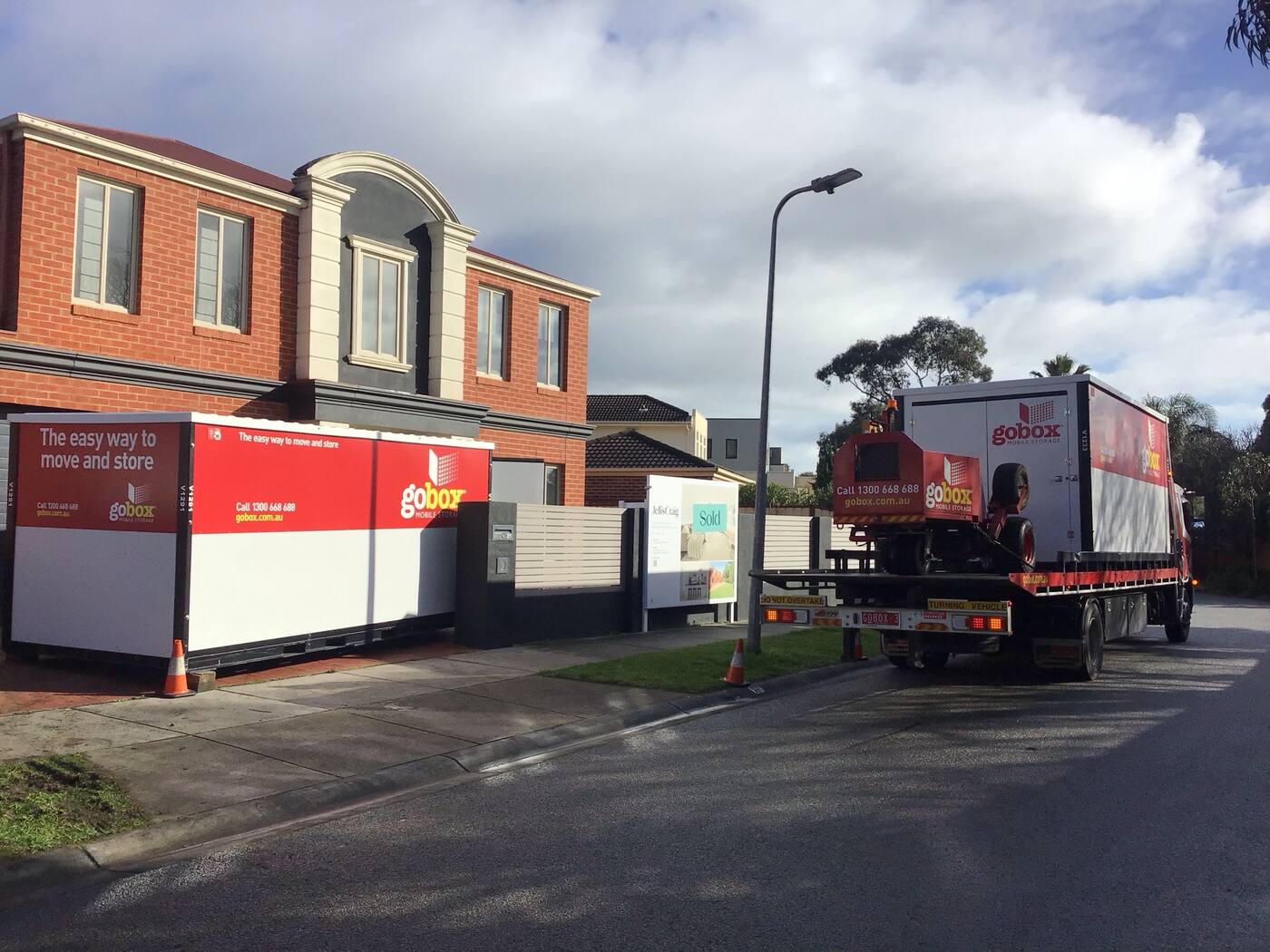 gobox unit on a driveway with the delivery truck behind it