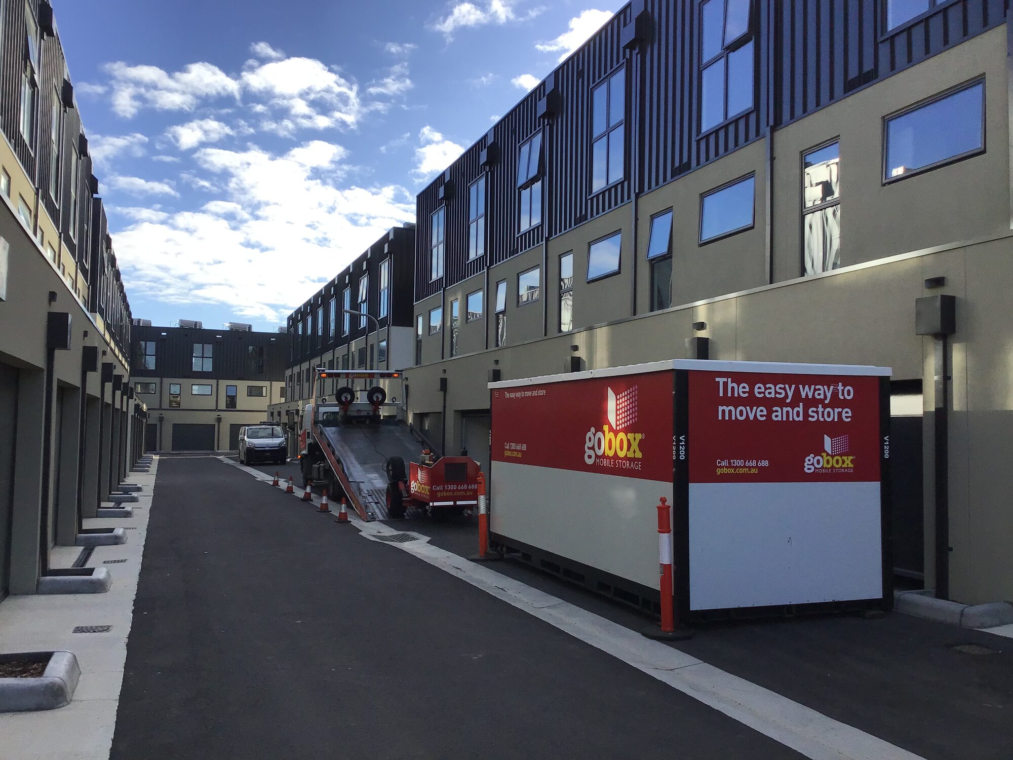 gobox truck delivering a storage unit in the laneway of a Melbourne townhouse development